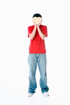 a boy with a heart covering his face