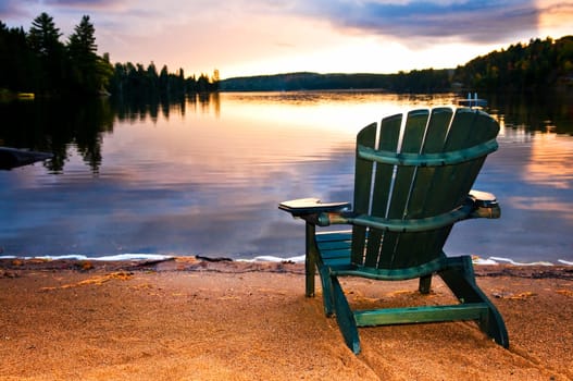 Wooden chair at sunset on beach