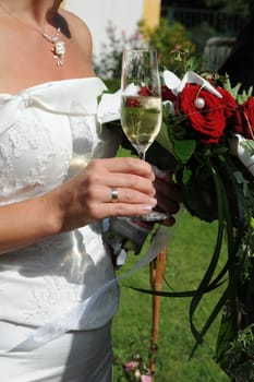 Bride with bridal bouquet and champagne glass