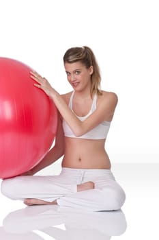 Fitness - Young woman with exercise ball on white