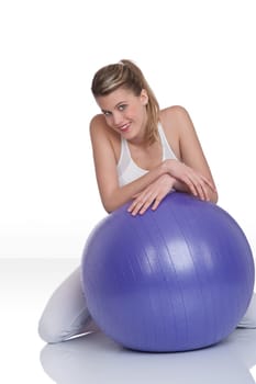 Fitness - Young woman with exercise ball on white
