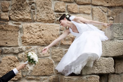 Bride reaching for bouquet