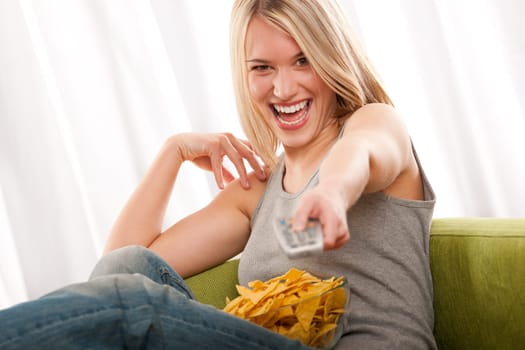 Student - young blond woman watch TV