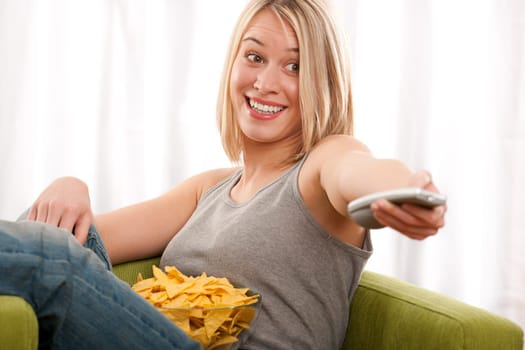 Student - young blond woman watch TV