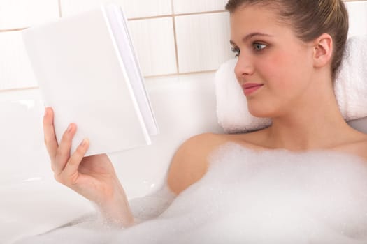 Body care - woman read book in bath