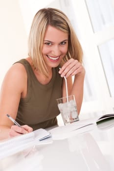 Student - blond woman write homework