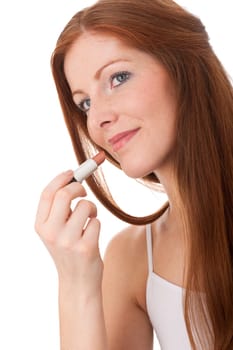 Body care - Beautiful red hair woman apply lipstick