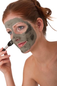 Body care series - Young woman apply facial mask