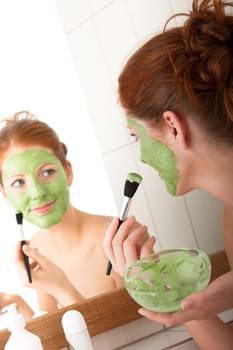 Body care - young woman with facial mask