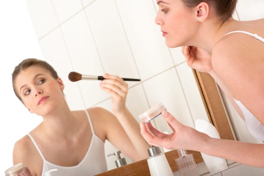 Body care - young woman apply powder