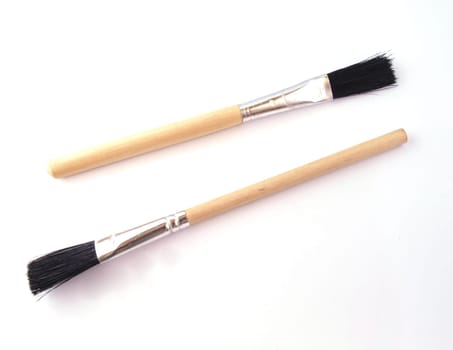 Two new paint brushes on a white background.
