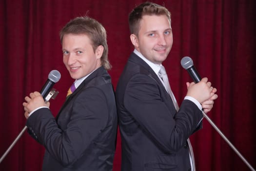two men with microphones