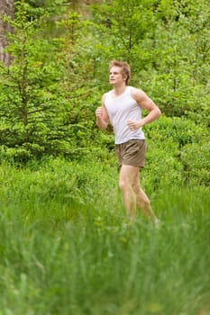 Morning run Young man jogging in nature