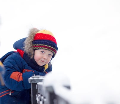child look at you on winter bridge