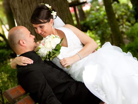 Bride and groom sitting on bench