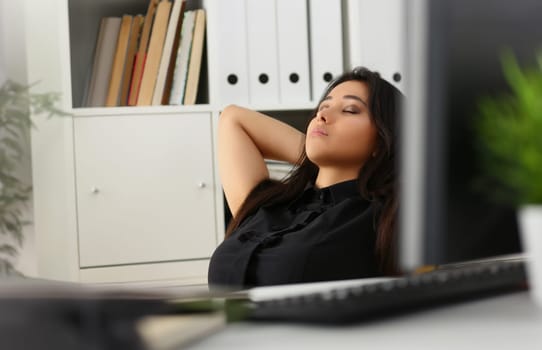 Portrait of female office worker having break, napping with closed eyes at work. Lazy clerk at work, kill time, tired. Job, pause, break, sleepy concept
