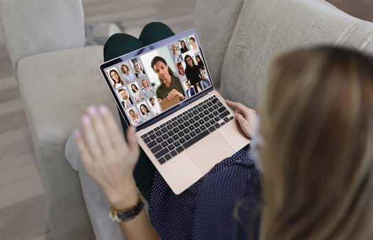 Close-up of young woman wave hi to coworkers connected online via video call, remote conference meeting. Freelancer, job, communication, technology concept
