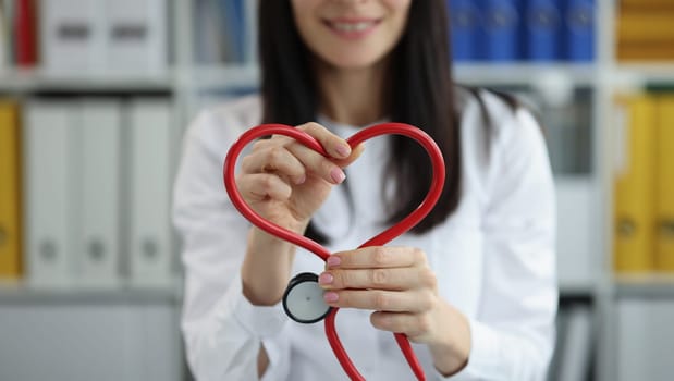 Close-up of medical worker make heart of stethoscope pipe, save life through donation or charity. Medicine, cardiology, healthcare, heart project concept