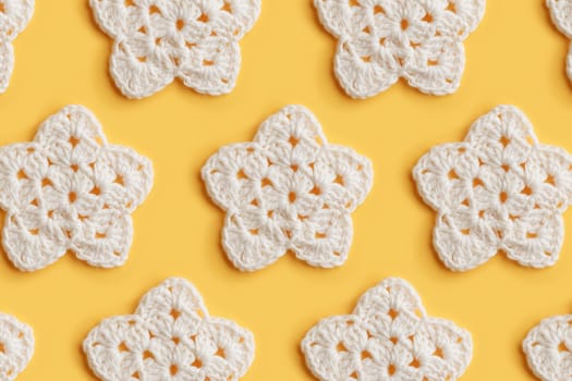 The white crocheted star on a bright background with copy space / pattern