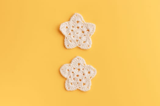 The white crocheted star on a bright background with copy space / pattern