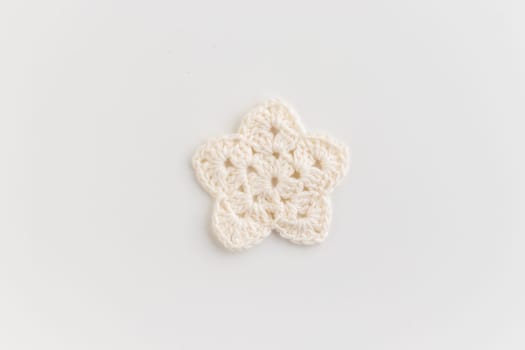 The white crocheted star pattern on a white background