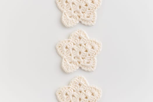 White crocheted stars row pattern on a white background