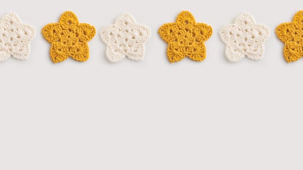 White and yellow crocheted stars pattern on a white background