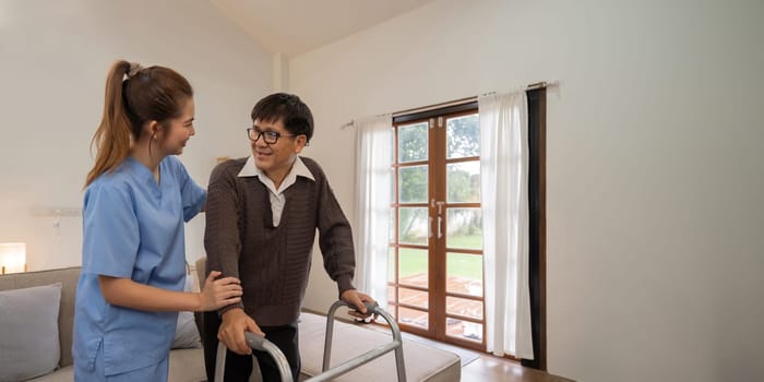 Support, trust and help from caregiver or nurse that helps support walking senior man or patient in home with healthcare insurance.