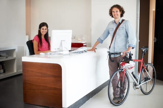 Man, office with bike and sustainable travel, worker in portrait with carbon footprint, transportation and creative at startup. Happy, cycling for eco friendly commute and professional at workplace.