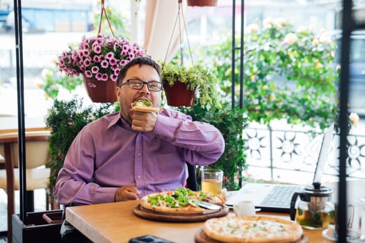man eats pizza in a restaurant pizzeria food fast food