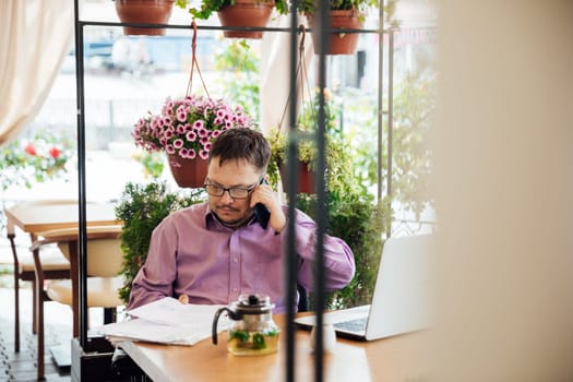 man works in a restaurant talking on the phone