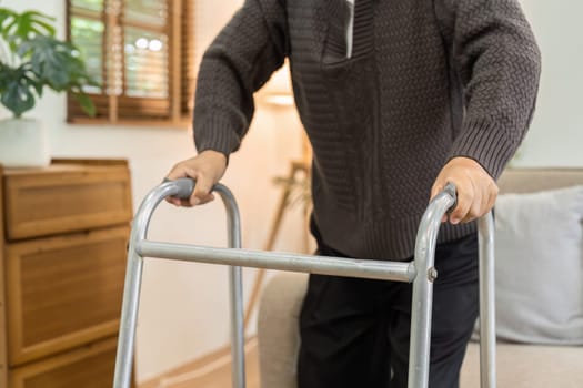 Retire senior using walker to help them walk at home. health care concept.