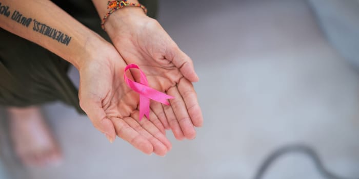 Pink October Breast Cancer Awareness month, doctor with pink ribbon symbol. National cancer survivors month. health care concept.