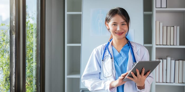 Portrait medical concept of Asian beautiful female doctor in white coat with stethoscope, waist up. medical.