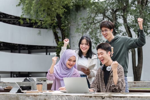 A group of multiracial students who are happy and successful in their studies. In college, laptops are used to check that academic results are on track..