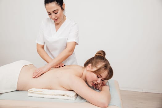 a relax spa back massage with stones in the massage room