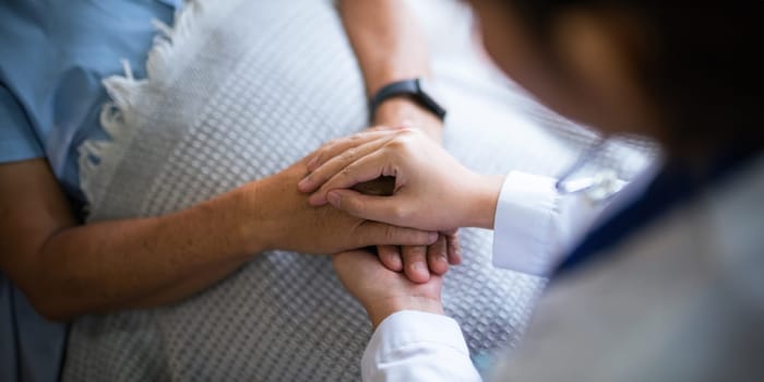 Empathy, trust and nurse caregiver holding hands with patient. consulting support and healthcare advice. Kindness, counseling and medical therapy in nursing home for hope, consultation and psychology.