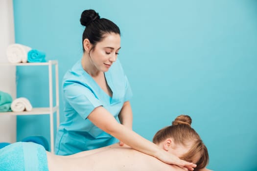 woman is given a back massage treatment in the office