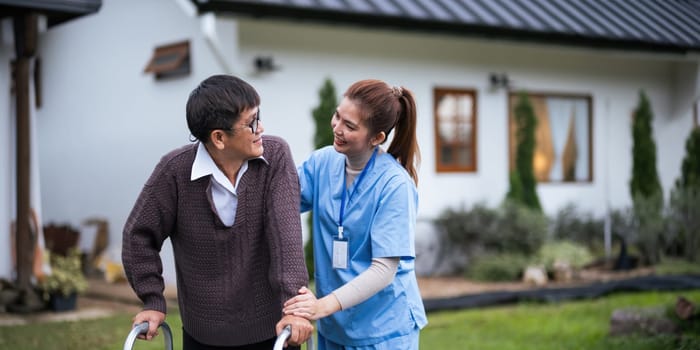 Nurse or caregiver hand on walking frame for support, help or trust moving leg in rehabilitation. Physiotherapy healthcare, Medical caregiver consulting disabled elderly patient at home.