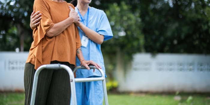 Nurse or caregiver hand on walking frame for support, help or trust moving leg in rehabilitation. Physiotherapy healthcare, Medical caregiver consulting disabled elderly patient at home.