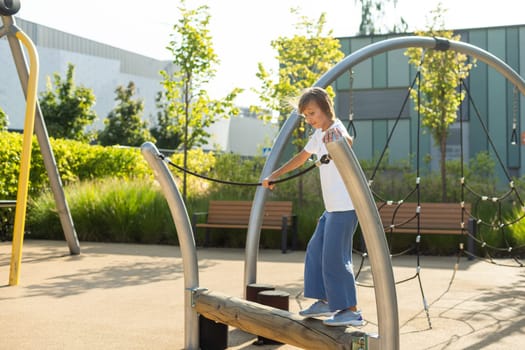 Teenager girl doing exercises on the school playground on a summer, sunny day. High quality photo