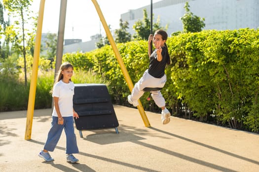 Girl playing on a swing in the park. High quality photo