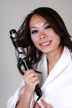 Girl curling her hair.