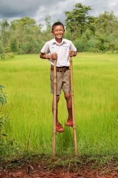 Boy walks on stilts