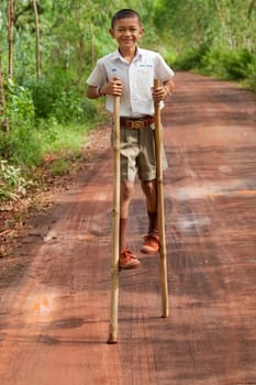 Boy walks on stilts
