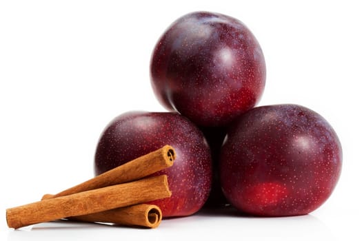 Three plums and cinnamon sticks