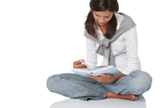 Attractive happy teenager reading book
