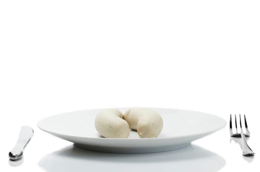 Two white sausages on plate