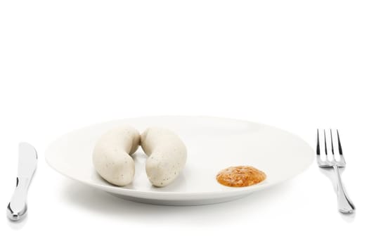White sausages with sweet mustard on plate