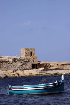 Fishing boat and fortified tower in Gozo
